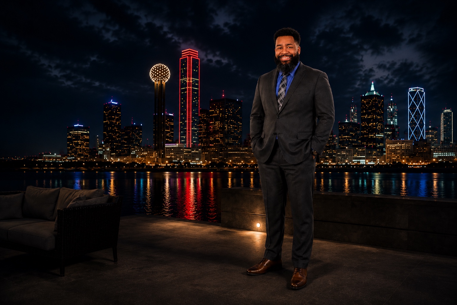 Tyshawn Miles standing before the Dallas skyline at night